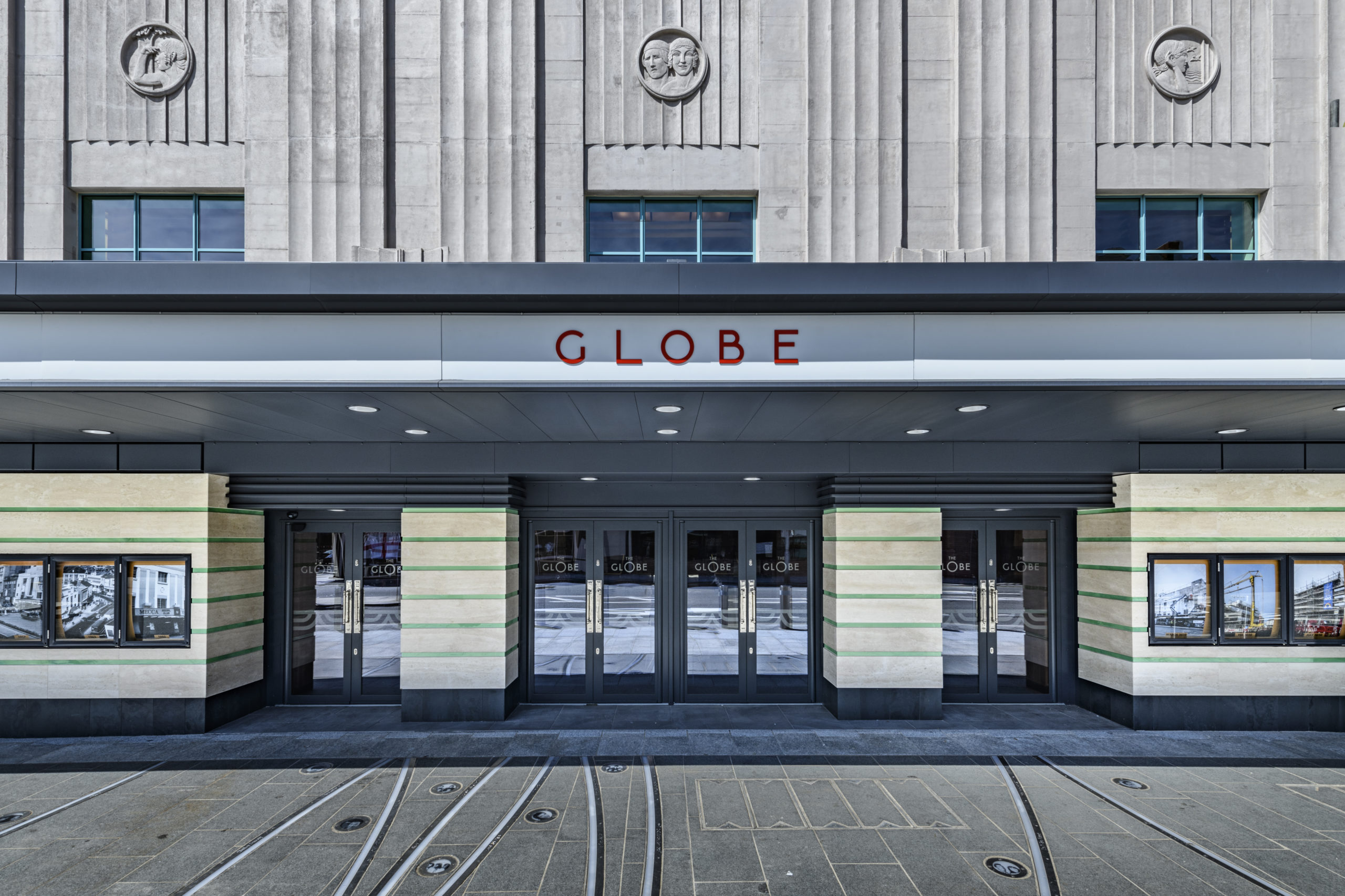 Black steel commercial french doors and bright blue windows for The Globe Theatre